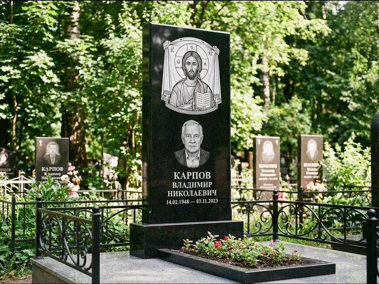 Памятник с гравировкой иконы: широкая двойная семейная стела — золочёный нимб на образе, цветник с красными розами, работа «Воронцова» в Ханты-Мансийске