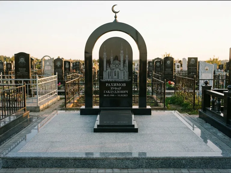 Мусульманский памятник с гравировкой мечети: монументальная стела-арка с полумесяцем на вершине — детализированная гравировка мечети Кул-Шариф, мощёная гранитная площадка с бордюром, работа «Юсупов» в Ханты-Мансийске